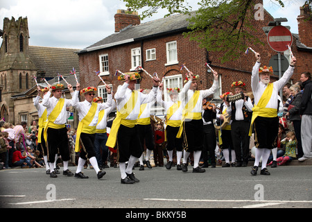 Morris men dancing during the annual Mayday procession throw the town of Knutsford Stock Photo