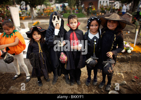 Girls and boys dressed in Halloween costumes visit the cemetery in San Gregorio Atlapulco on the outskirts of Mexico City Stock Photo