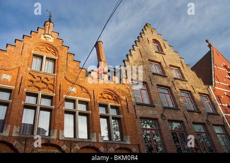 Late afternoon sunlight against the medieval stepped roofs of Bruges Belgium Stock Photo