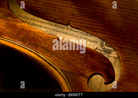 Violin Maker Signature Close view through the F sound hole to makers label and authentic signature on a fine William Forster English violin c1790 Stock Photo