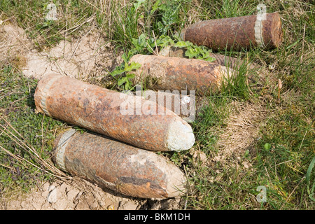 First World War artillery shells and poppies by the roadside near ...