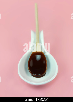 A wooden spoon covered in melted chocolate Stock Photo