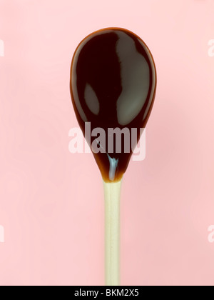 A wooden spoon covered in melted chocolate Stock Photo