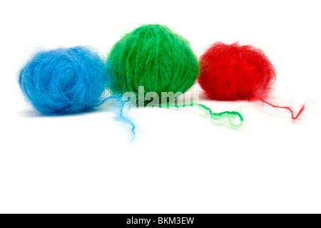 A line up of red, green and blue balls of mohair wool isolated against white background. Stock Photo