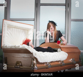 A Young Couple Views A Deceased Loved One In A Coffin Stock Photo - Alamy