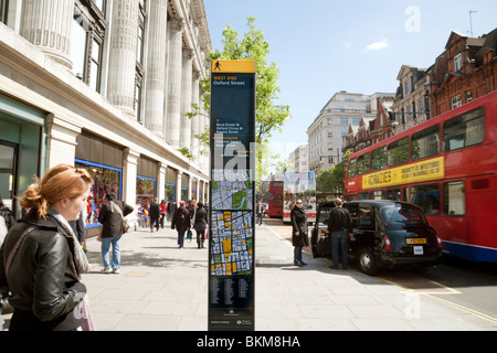 Buses and taxis outside Selfridges store, Oxford Street, London UK Stock Photo