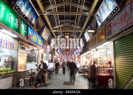 Endless lighting billboards and people shopping at night in Huaxi Street Tourist Night Market, Wanhua District, Taipei City, Taiwan Stock Photo