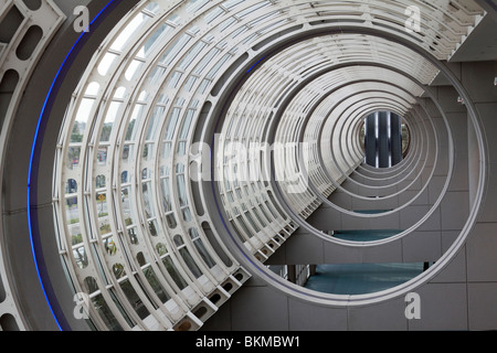 Concentric circles in the ceiling of the San Diego Convention Center atrium leading to three escalators Stock Photo