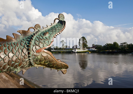 Cannon on the Kuching Waterfront with The Astana (Palace) across river. Kuching, Sarawak, Borneo, Malaysia. Stock Photo