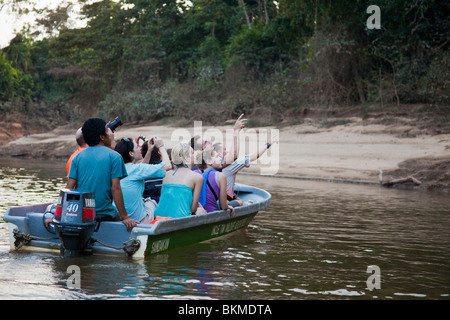 Eco tourists on a wildlife cruise on the Kinabatangan River, Sabah, Borneo, Malaysia. Stock Photo