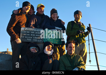 Group of climbers at the summit of Mt Kinabalu at Low's Peak (4100 metres). Kinabalu National Park, Sabah, Borneo, Malaysia. Stock Photo