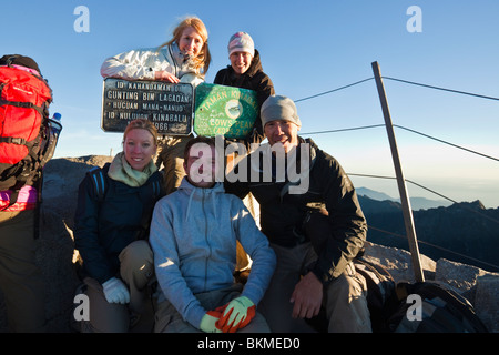 Group of climbers at the summit of Mt Kinabalu at Low's Peak (4100 metres). Kinabalu National Park, Sabah, Borneo, Malaysia. Stock Photo