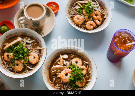 Bowls of prawn laksa - a Malaysian speciality. Kuching, Sarawak, Borneo, Malaysia. Stock Photo