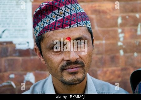 A Nepali man wearing a traditional Nepali hat. Stock Photo