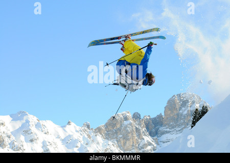 A telemark skier does a front flip as he jumps a drop off piste in the ski resort of Courchevel in the French Alps Stock Photo