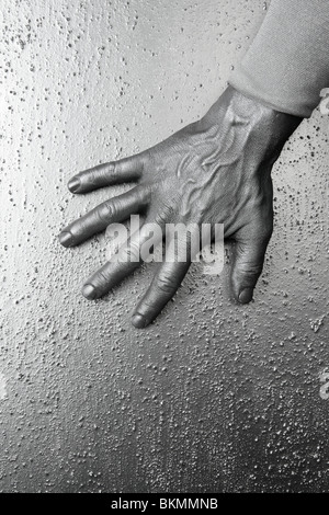 male futuristic man silver hand over textured steel background Stock Photo