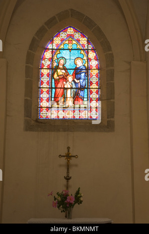 Stained Glass Window with Altar Below in a Small Chapel near Saint Bartholomews Square in Najac Aveyron Midi-Pyrenees France Stock Photo