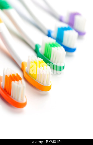 Five multicolored toothbrushes on white background Stock Photo - Alamy