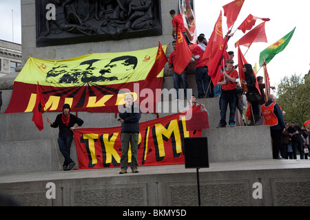 May Day march and rally at Trafalgar Square, May 1st, 2010 banners and red flags on Nelson's Column Stock Photo
