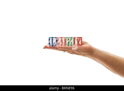 Woman holding children's blocks that spell 'LAZY' Stock Photo