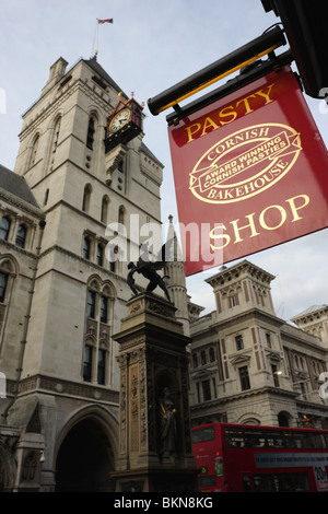 The clock tower of the Royal Courts of Justice oversees the Temple Bar Memorial in London`s Strand junction of Fleet Street. Stock Photo