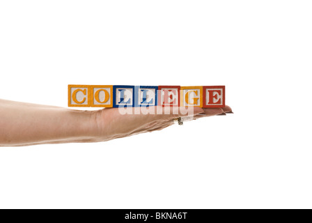 Woman holding children's blocks that spell 'COLLEGE' Stock Photo