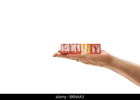 Woman holding children's blocks that spell 'EASY' Stock Photo