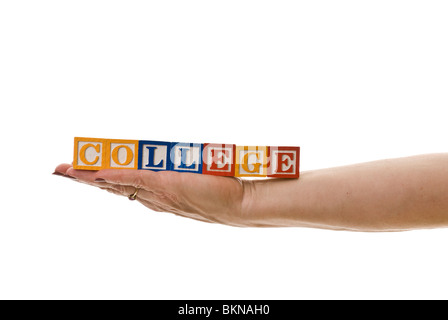 Woman holding children's blocks that spell 'COLLEGE' Stock Photo