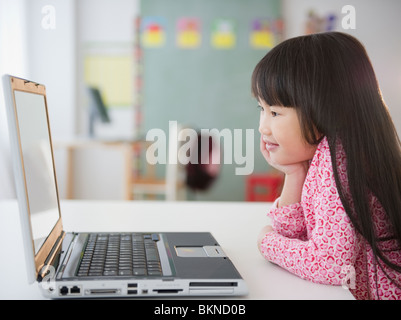 Chinese girl using laptop in classroom Stock Photo