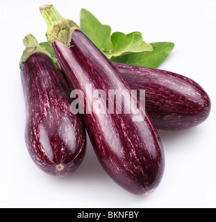 Purple eggplants with leaves on white background Stock Photo