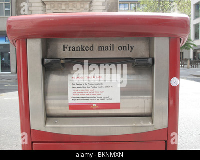 Red post box Franked mail business 'Royal Mail'  postage London UK Stock Photo