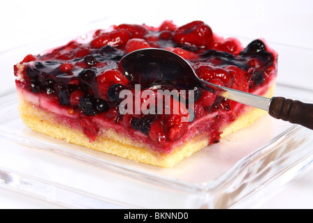 fruit cake in glass plate on white background Stock Photo