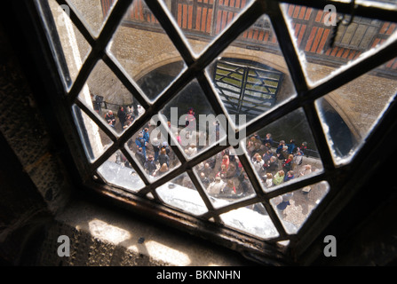 A Yeoman warder or Beefeater guiding tourists near Traitor's gate in the Tower of London Stock Photo