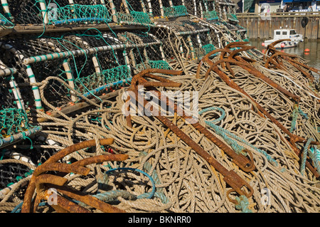 Rusty anchors anchor on pile of ropes on the quayside Bridlington East Yorkshire England UK United Kingdom GB Great Britain Stock Photo