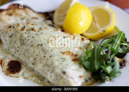 Authentic Cooked Fresh Sea Bass Fillet In Chervil Sauce Served On A Plate With No People Stock Photo