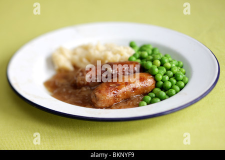 Traditional British Warming Comfort Food Of Pork Sausages With Mashed Potatoes,  Peas and Gravy Served On A Plate With No People Stock Photo