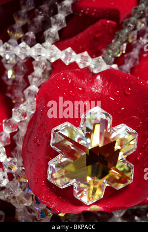 Shiny jewelry over bed or red rose petals Stock Photo