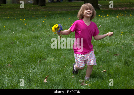 Detroit, Michigan - A girl in a park with a bouquet of dandelions. Stock Photo