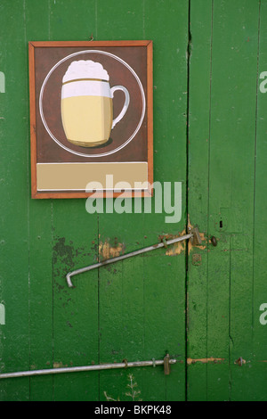 Beer draw hand painted poster in a green wooden door Stock Photo