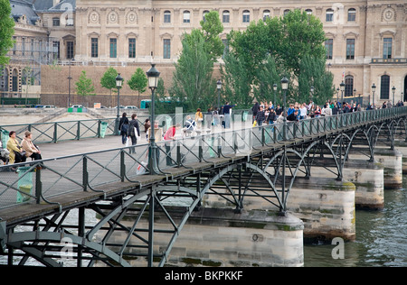 Pedestrians crossing Pont des Arts bridge in Paris, France Stock Photo