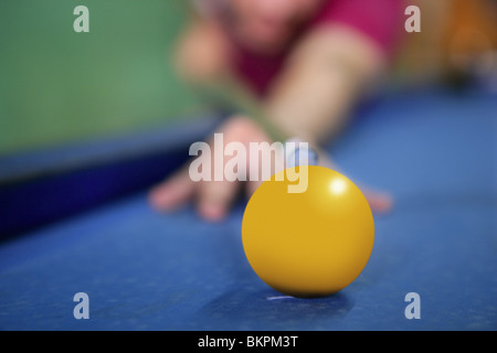 billiard yellow ball player hand holding cue selective focus Stock Photo