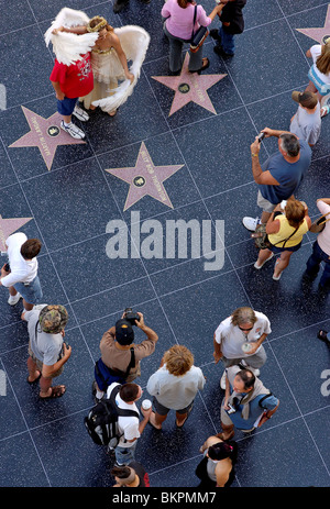 Stock photograph of overhead view of a street performer dressed as an angel working on the Walk of Fame Hollywood California USA Stock Photo