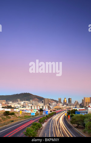 Early morning view of traffic trails on Eastern Boulevard leading into the city of Cape Town, South Africa. Stock Photo