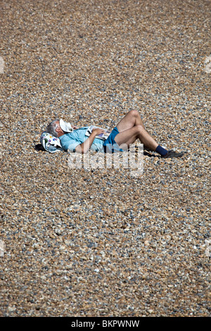 Man Sleeping on Brighton Beach East Sussex England UK Stock Photo