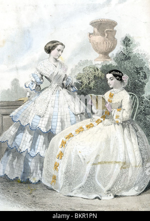 Two Women in Traditional Victorian Costume in a Courtyard Stock Photo
