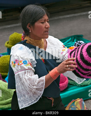 Ecuador, An indigenous Ecuadorian woman selling woollen hats at Otavalo market. Stock Photo