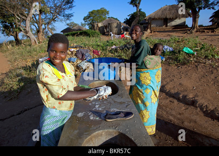 Malawi, Lilongwe, Ntchisi Forest Reserve. In a small mountain village woman gather at the communal washing area. Stock Photo