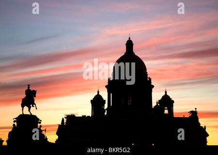 Russia, St.Petersburg; St.Isaac's Cathedral in silhoutte against a dramatic eveing light with the Tsar Nicholas IInd's statue Stock Photo