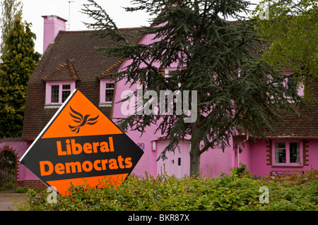 Liberal Democrat Party poster displayed on a private hedge outside a pink painted house in a suburb of Leicestershire. Stock Photo