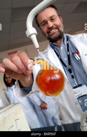 College students with tutor in chemistry laboratory Stock Photo